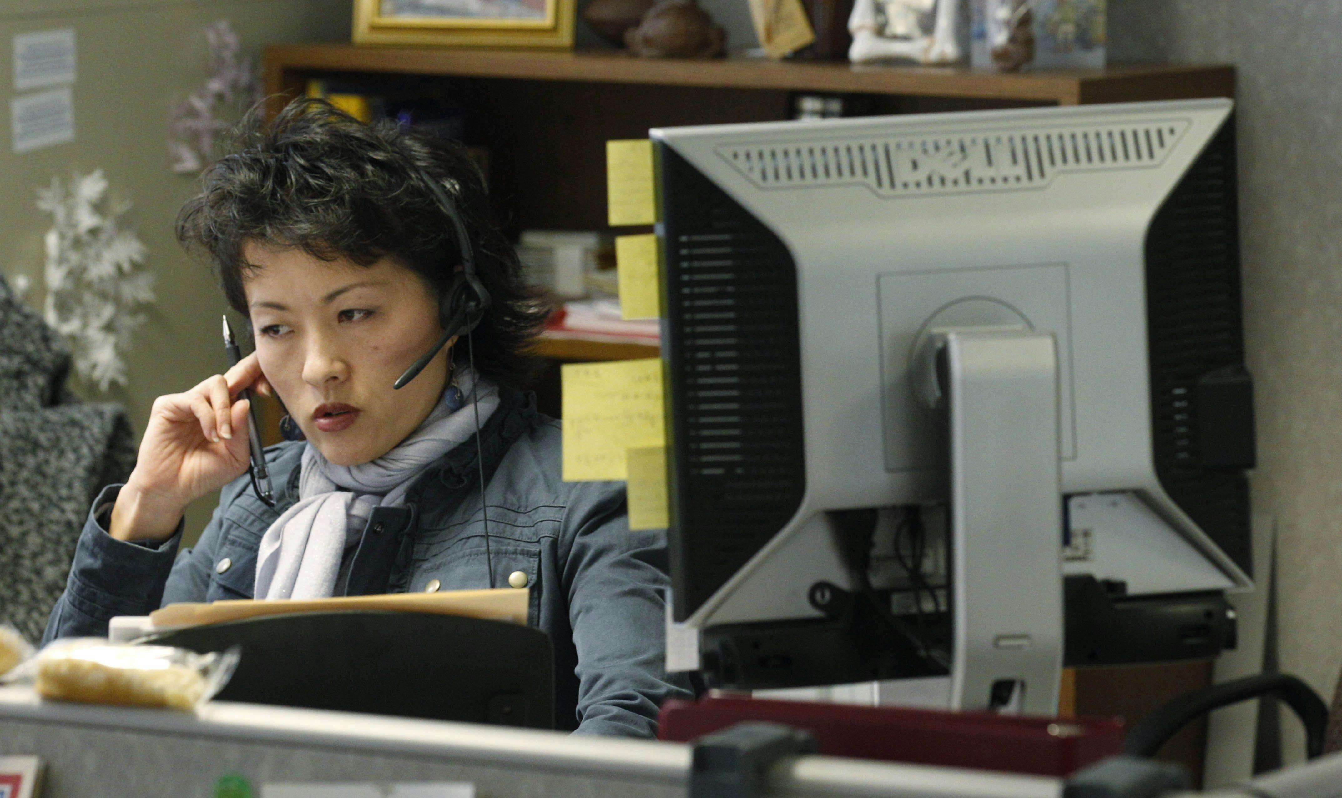 a woman with a headset and a computer monitor at a mental health call center