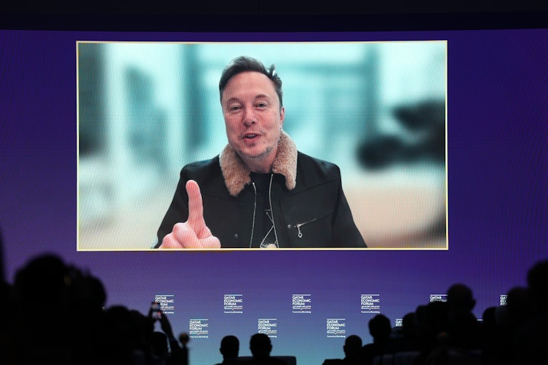Elon Musk raises his finger and speaks during a livestream Q&A at the Qatar Economic Forum