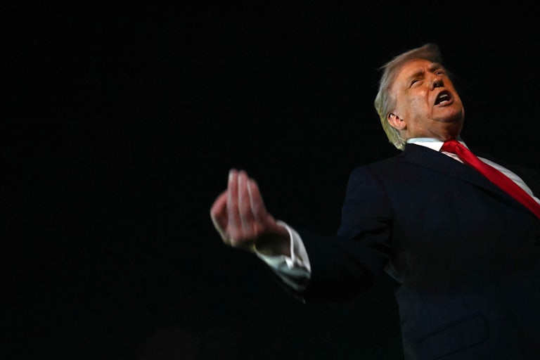 Donald Trump gestures and speaks before boarding Air Force One.