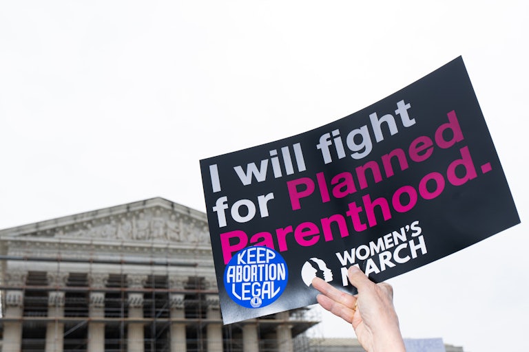 A person holds up a sign that says, "I will fight for Planned Parenthood" outside the Supreme Court in Washington, D.C.