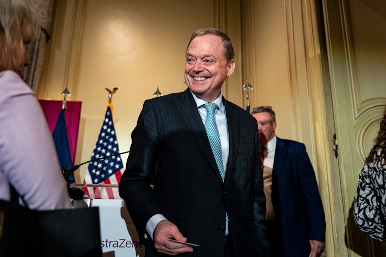 Kevin Hassett, director of the National Economic Council, smiles as others walk nearby.