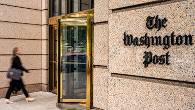 A woman walks into The Washington Post building