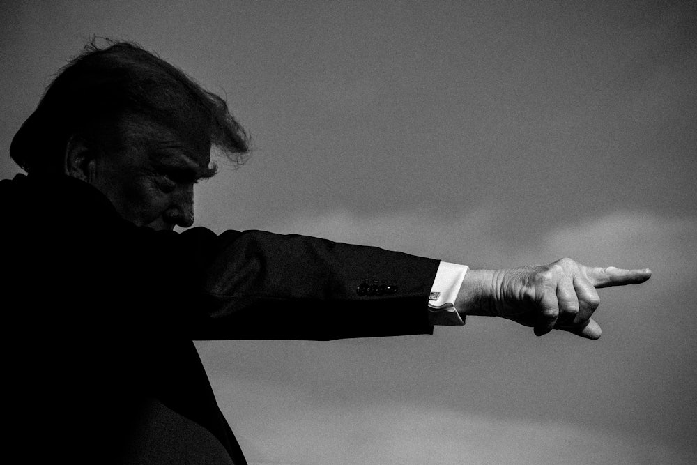 Donald Trump giving a speech and pointing