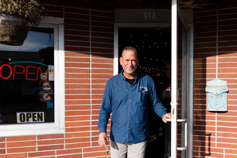 Dan Osborn walks out of a restaurant after a campaign event