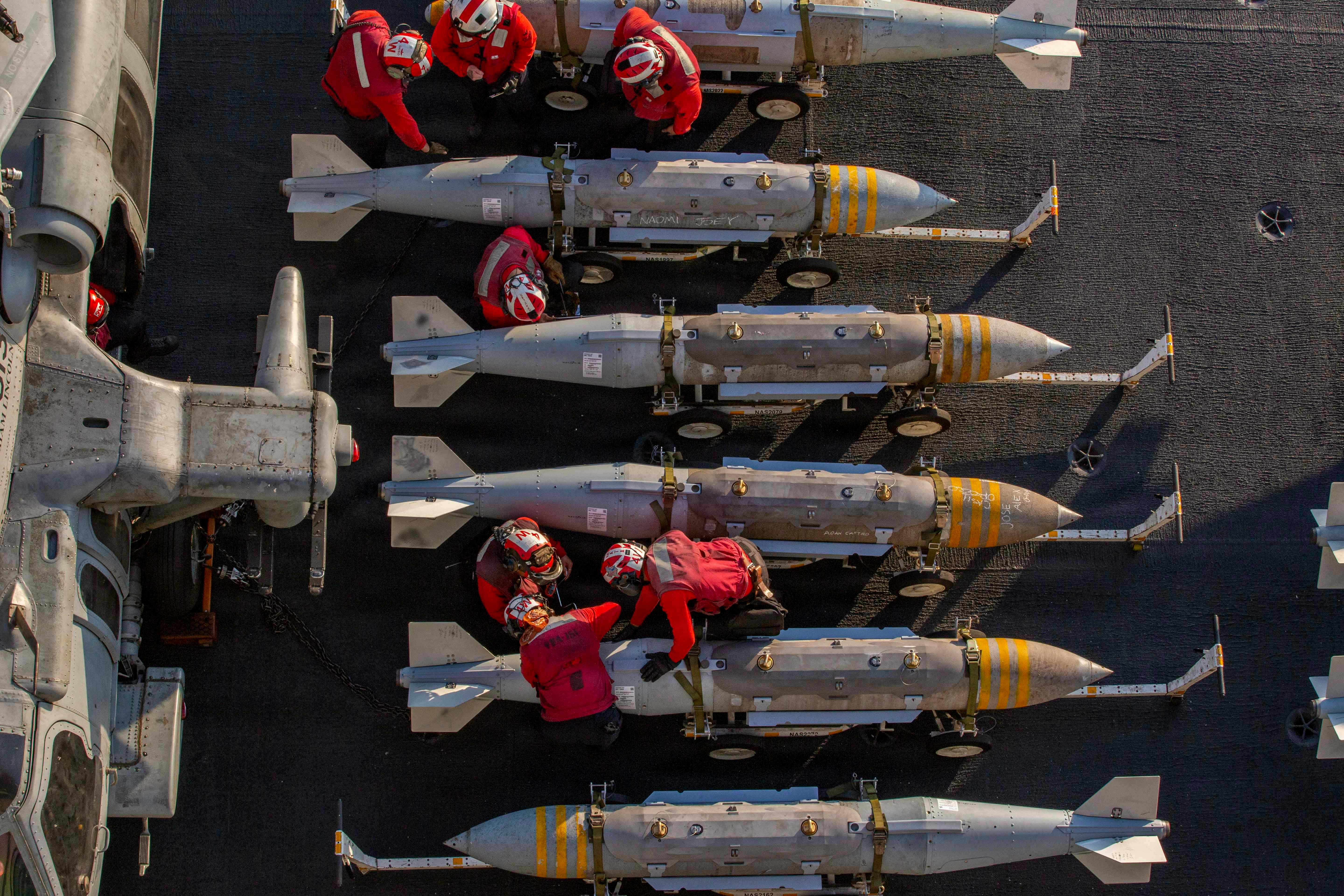 The U.S. Navy prepares to stage ordnance on the flight deck of aircraft carrier USS Abraham Lincoln in support of Operation Epic Fury on February 28, 2026