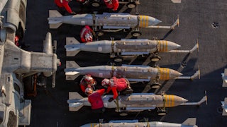 The U.S. Navy prepares to stage ordnance on the flight deck of aircraft carrier USS Abraham Lincoln in support of Operation Epic Fury on February 28, 2026