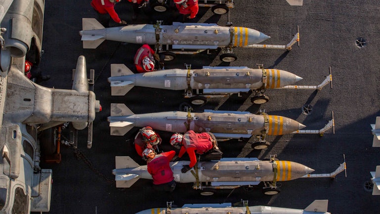 The U.S. Navy prepares to stage ordnance on the flight deck of aircraft carrier USS Abraham Lincoln in support of Operation Epic Fury on February 28, 2026