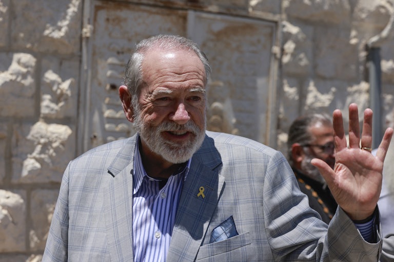 Mike Huckabee smiles and waves