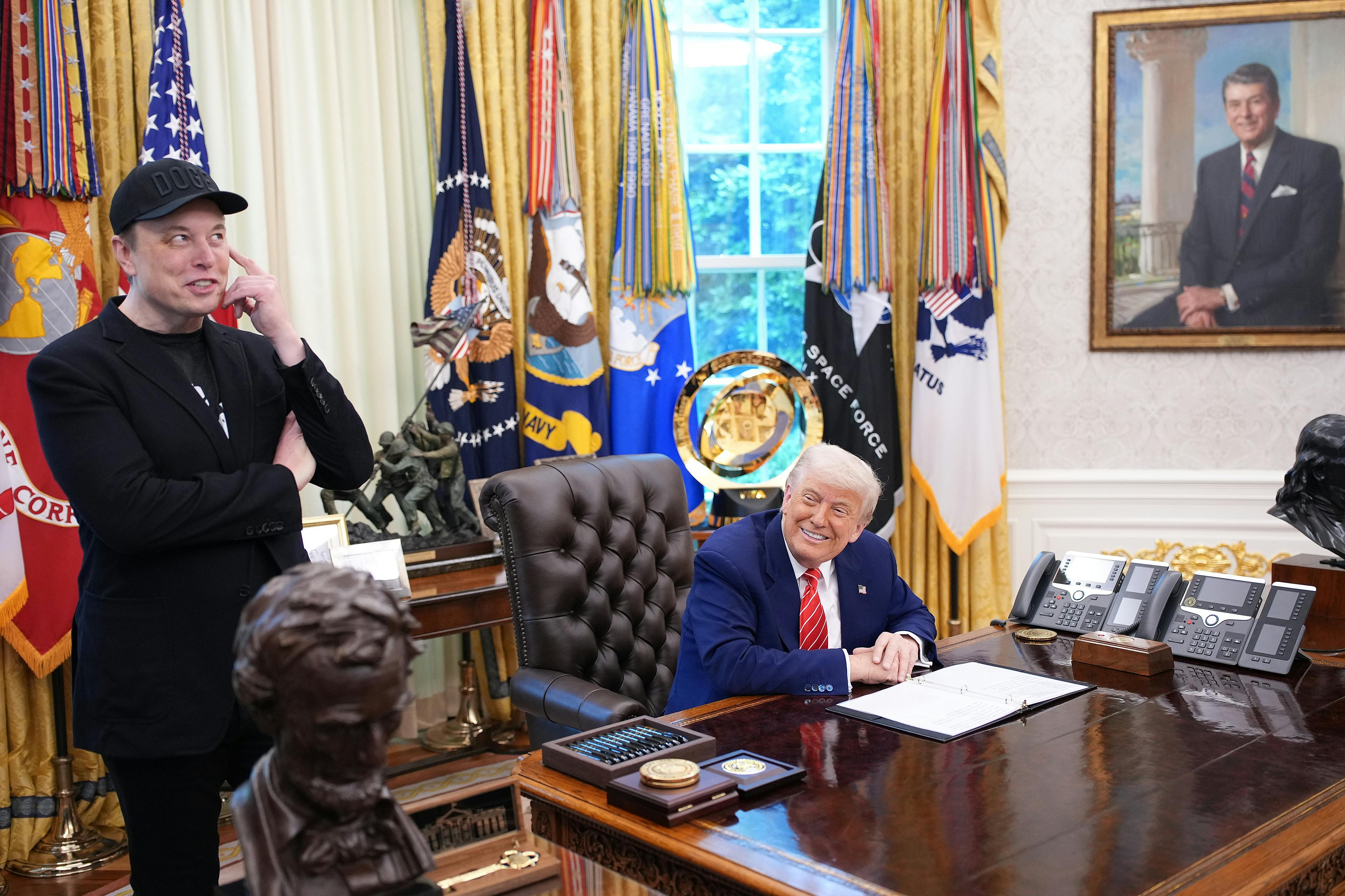 Elon Musk speaks alongside Donald Trump to reporters in the Oval Office of the White House.