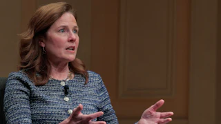 Supreme Court Justice Amy Coney Barrett gestures and speaks