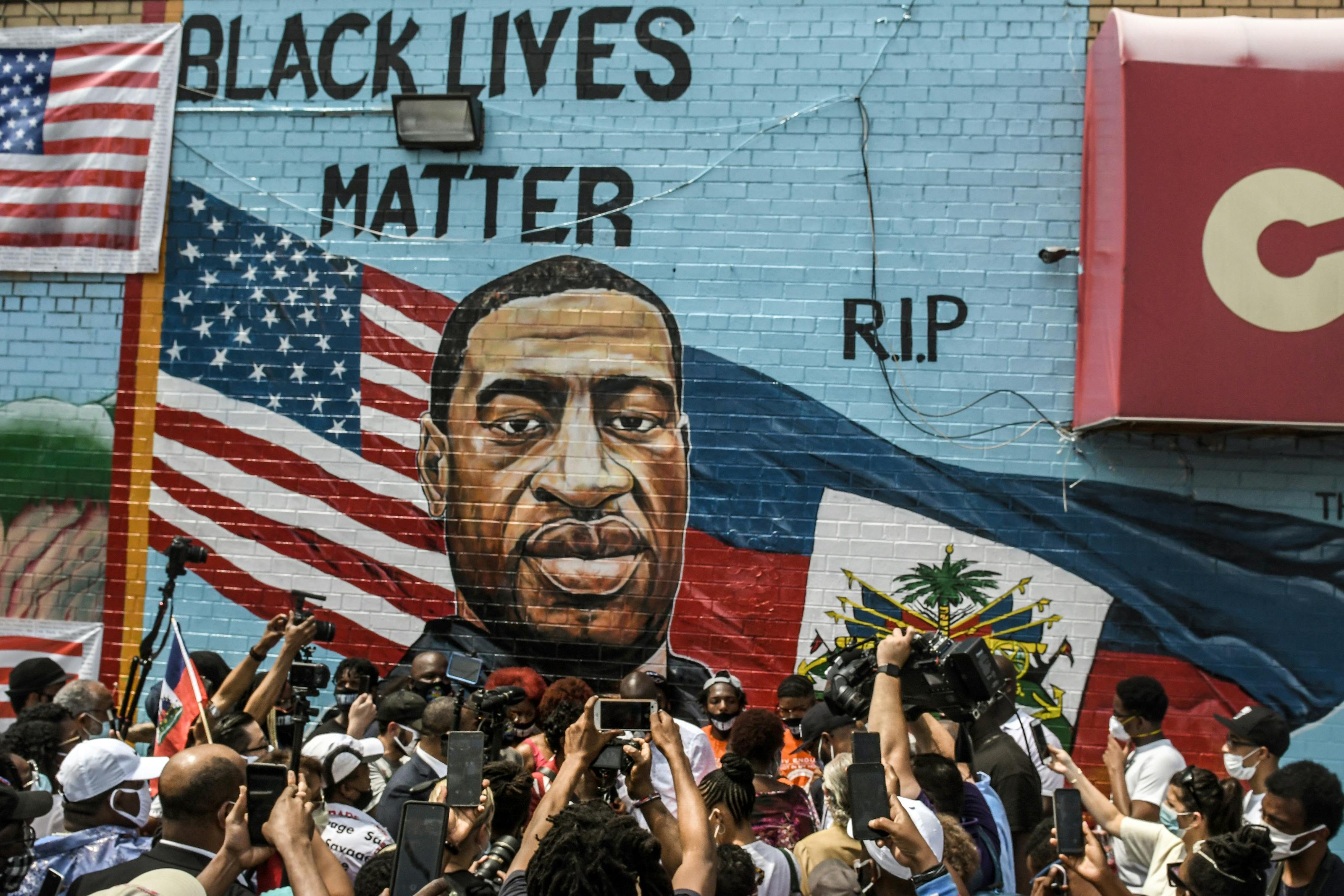 A mural painted by artist Kenny Altidor depicting George Floyd is unveiled in the Brooklyn, New York.