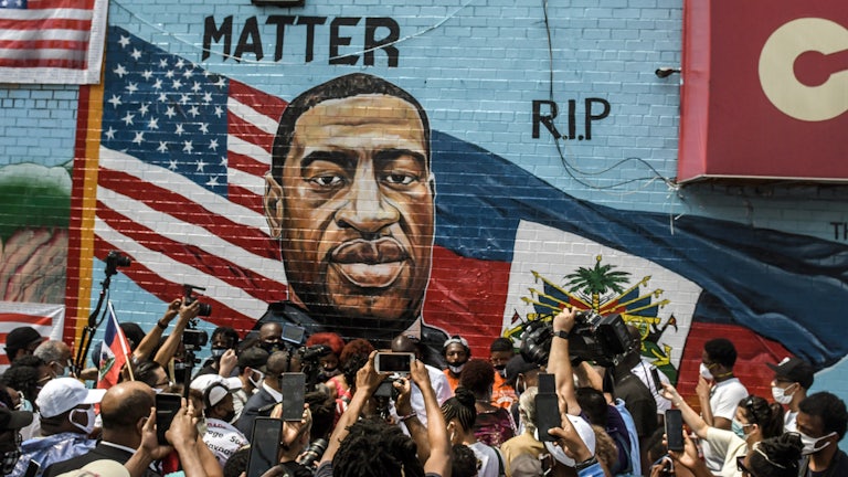 A mural painted by artist Kenny Altidor depicting George Floyd is unveiled in the Brooklyn, New York.