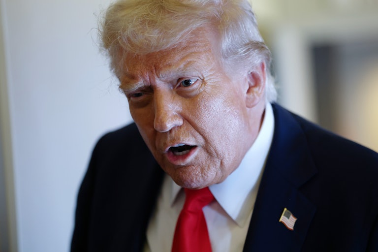 Donald Trump speaks to reporters on Air Force One