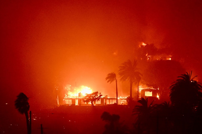 Houses near the Pacific Coast Highway in Pacific Palisades, California, burn