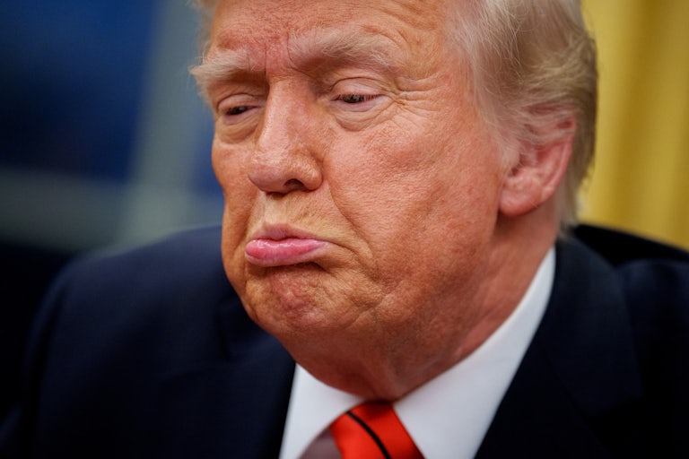 Donald Trump makes a face during a press conference in the Oval Office
