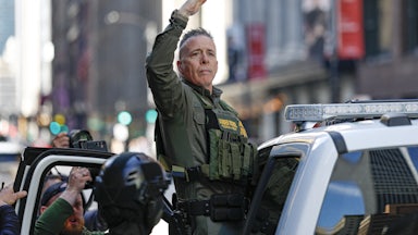 CBP Chief Gregory Bovino raises his hand while getting into a car outside the federal courthouse in Chicago