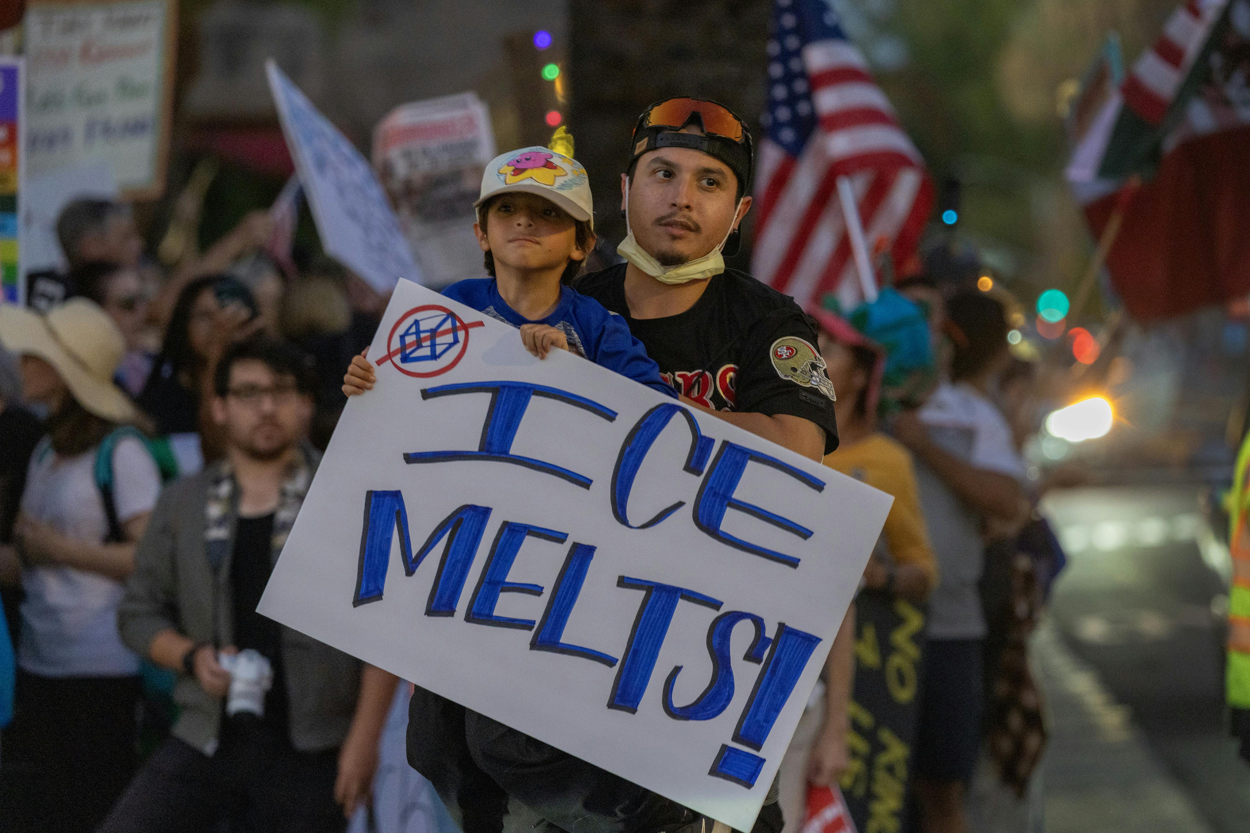 A child holds a sign that says "ICE melts!" during a No Kings protest in California