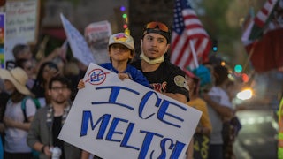 A child holds a sign that says "ICE melts!" during a No Kings protest in California