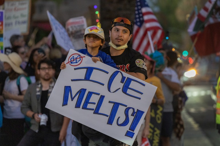 A child holds a sign that says "ICE melts!" during a No Kings protest in California