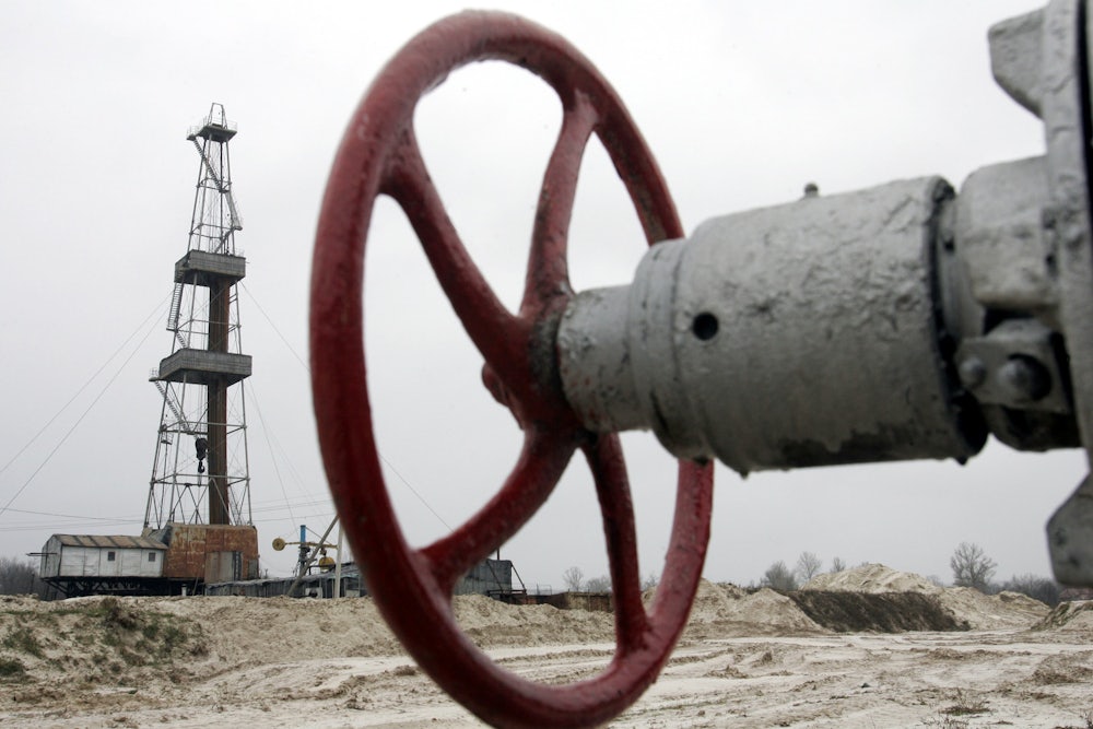 A wheel to shut off a valve appears in the foreground, with further infrastructure in the background.