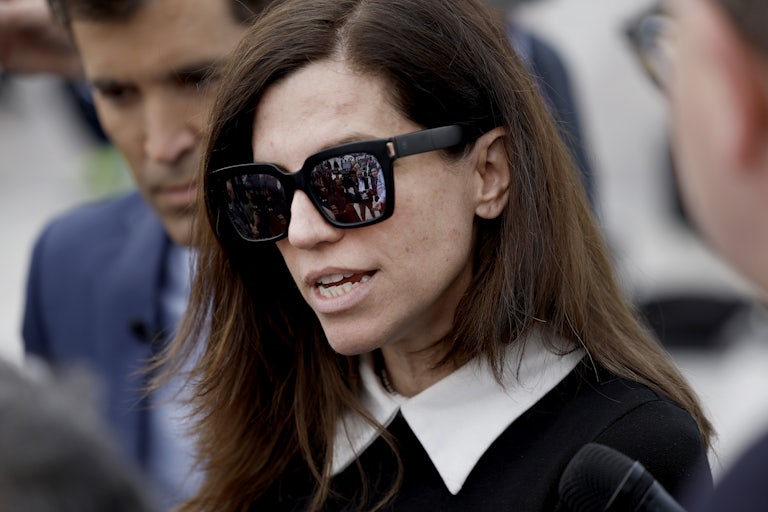 Nancy Mace wearing sunglasses outside speaks with reporters