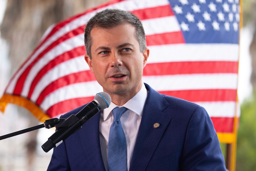 Pete Buttigieg speaks in front of an American flag