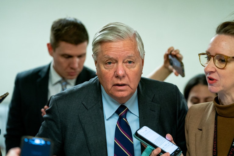 Lindsey Graham walks past reporters