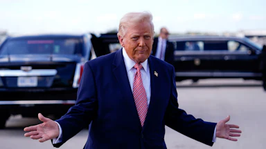 Donald Trump holds his hands out to the side and makes a weird face