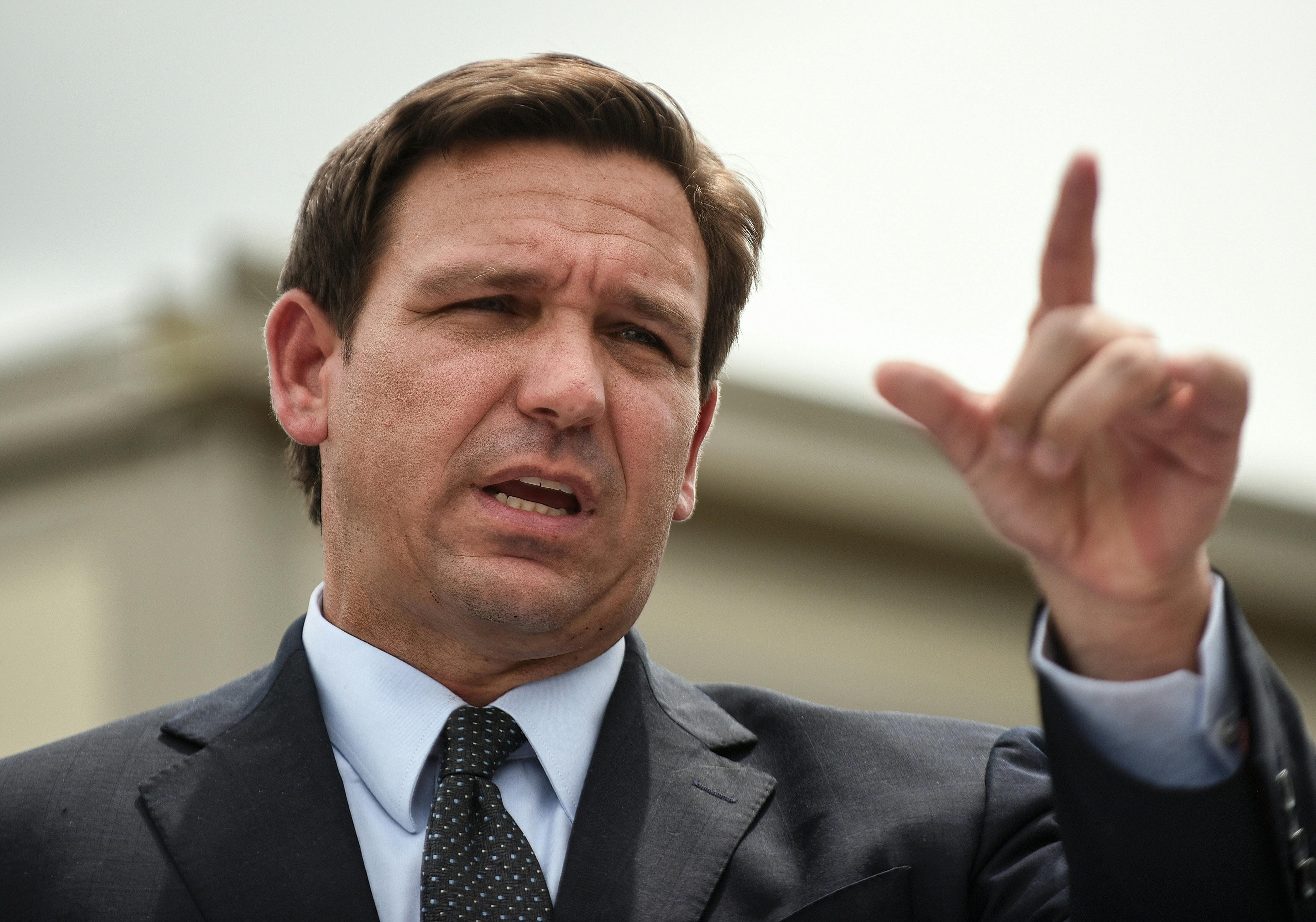 Governor Ron DeSantis gestures while speaking.