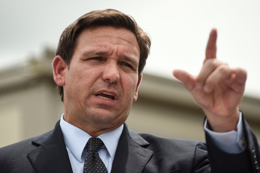 Governor Ron DeSantis gestures while speaking.