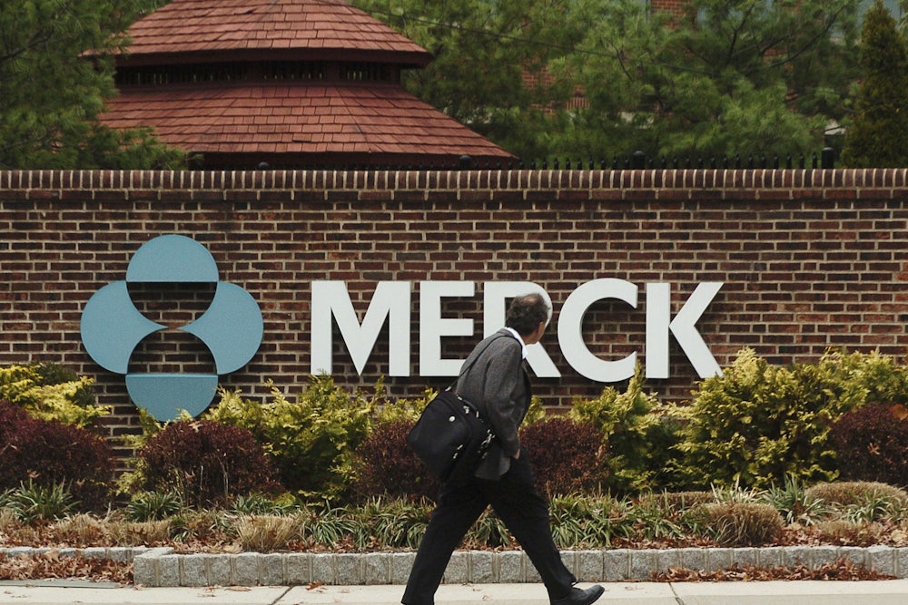 A man walks past the front of the Merck Pharmaceuticals plant in Rahway, New Jersey.