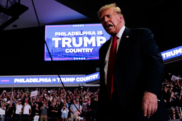 Donald Trump speaks as he walks