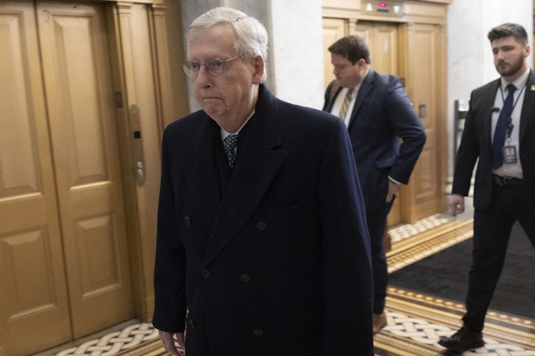 Mitch McConnell walking through the halls of Congress. He is legit sulking in this photo.