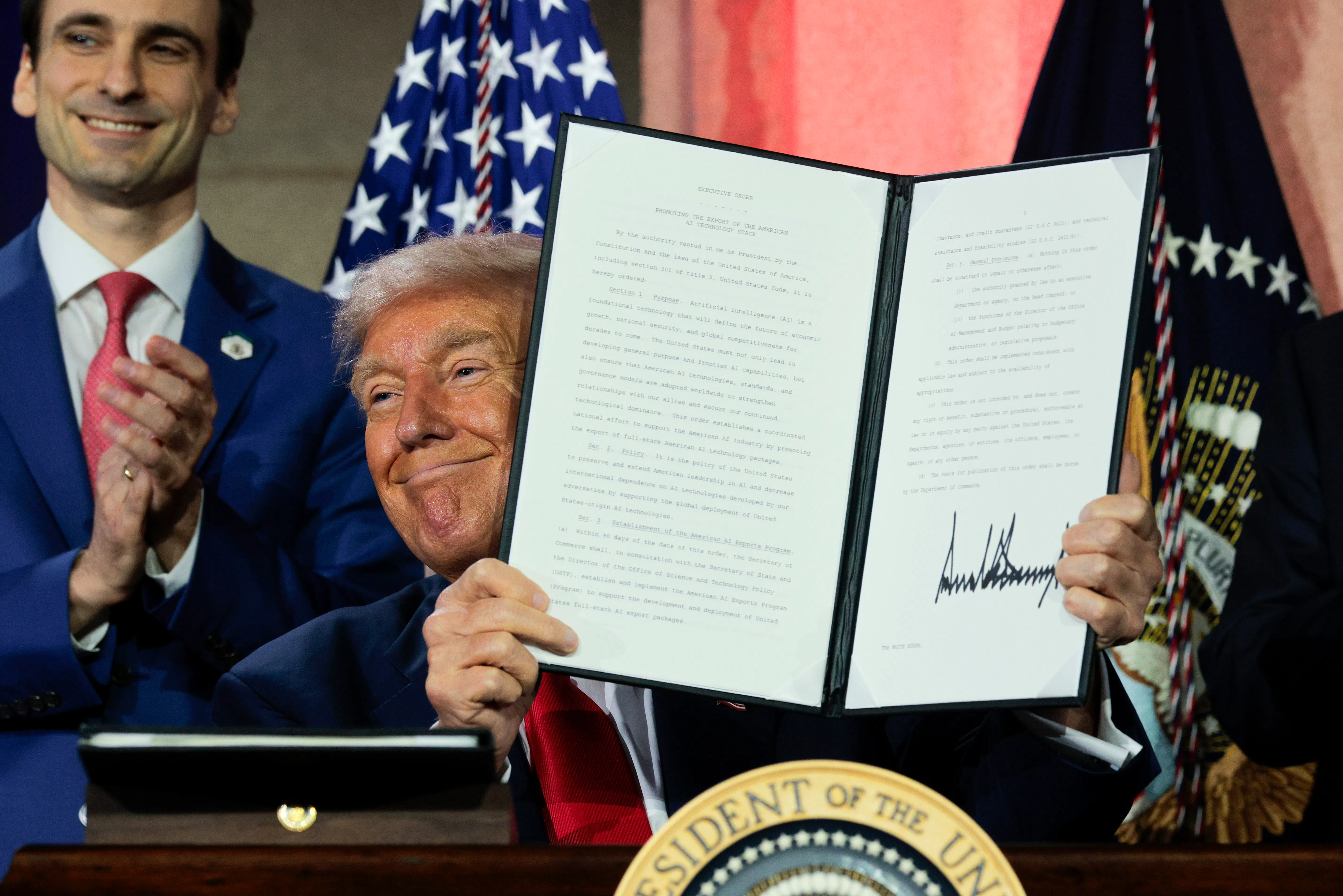 President Trump displays a signed executive order during the Winning the AI Race summit on July 23, 2025.