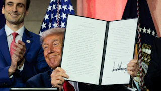 President Trump displays a signed executive order during the Winning the AI Race summit on July 23, 2025.