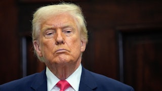 Donald Trump stands during a press conference