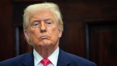 Donald Trump stands during a press conference