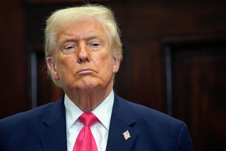 Donald Trump stands during a press conference