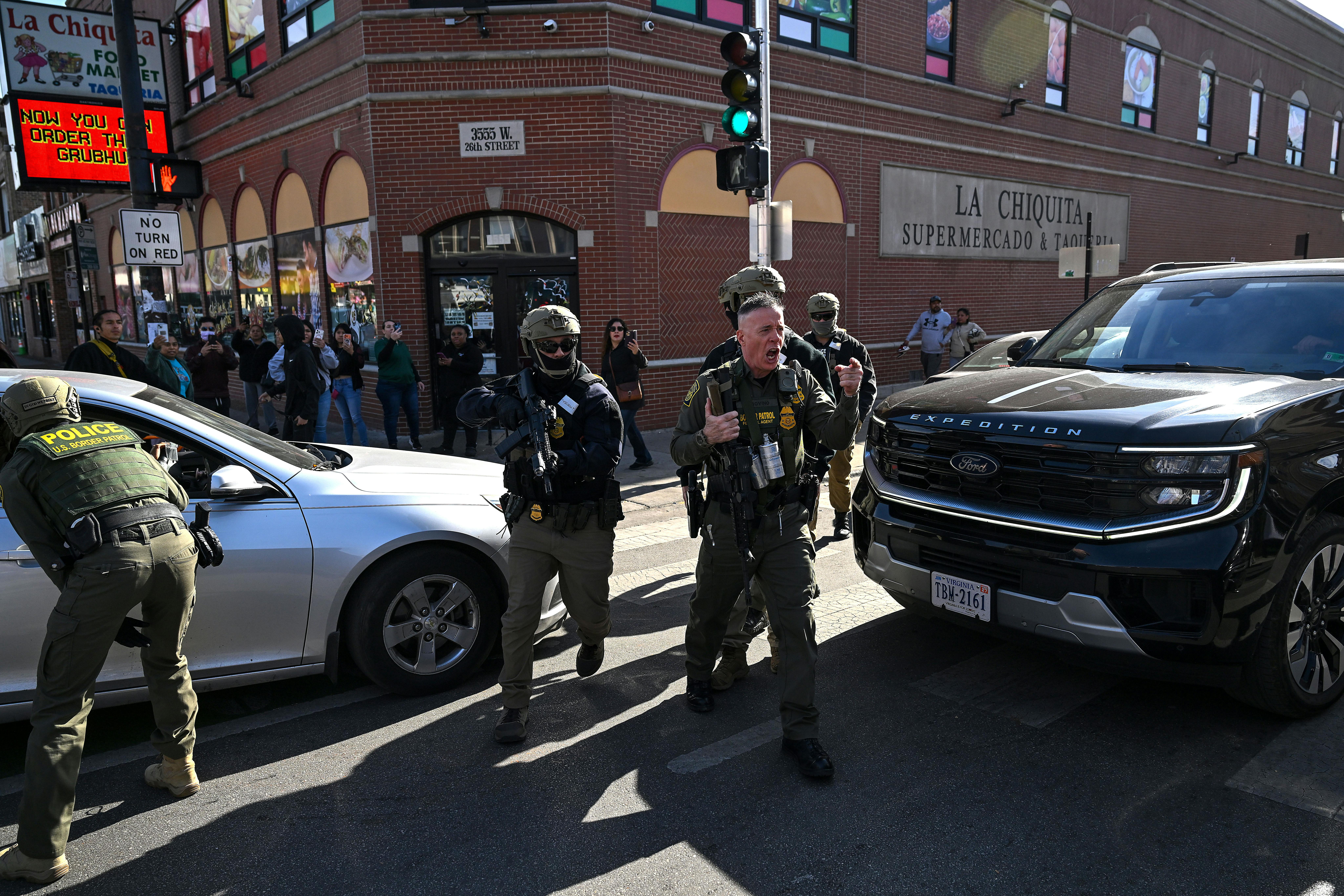 CBP Chief Gregory Bovino yells while walking in Chicago with masked federal immigration agents