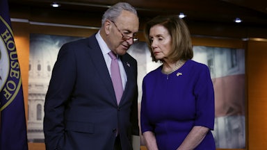 Senate majority leader Chuck Schumer and House Speaker Nancy Pelosi confer with each other.