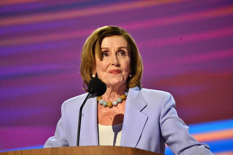 Nancy Pelosi stands at a podium