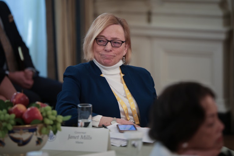 Maine Governor Janet Mills sits at a table during an event with Donald Trump at the White House