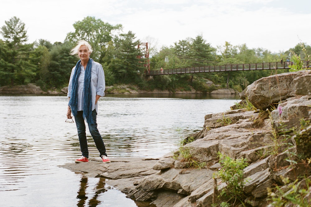 Elizabeth Strout stands in front of the Androscoggin River in Topsham, Maine in 2022