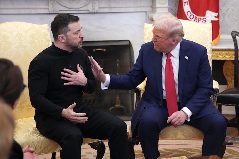 Donald Trump puts his hand on Volodymyr Zelenskiy's shoulder, as they sit and speak in the Oval Office