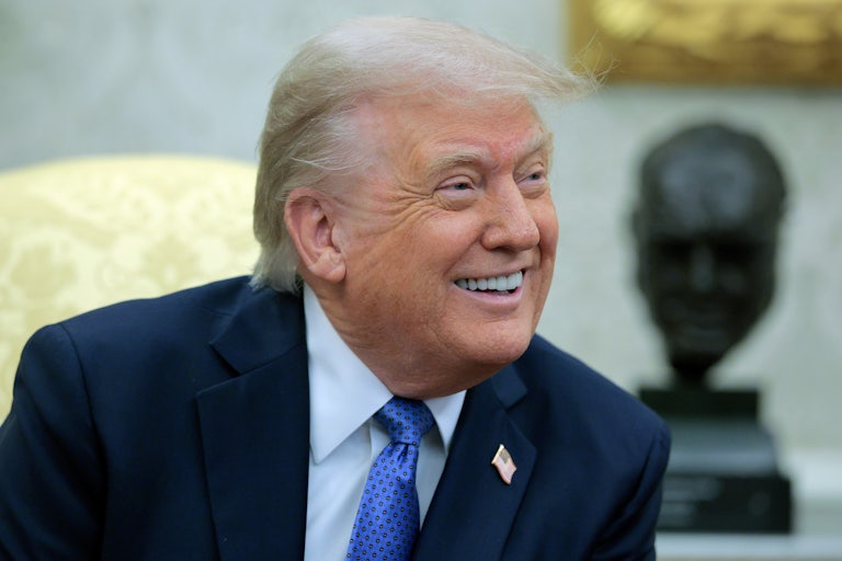 Donald Trump smiles in his gold Oval Office.