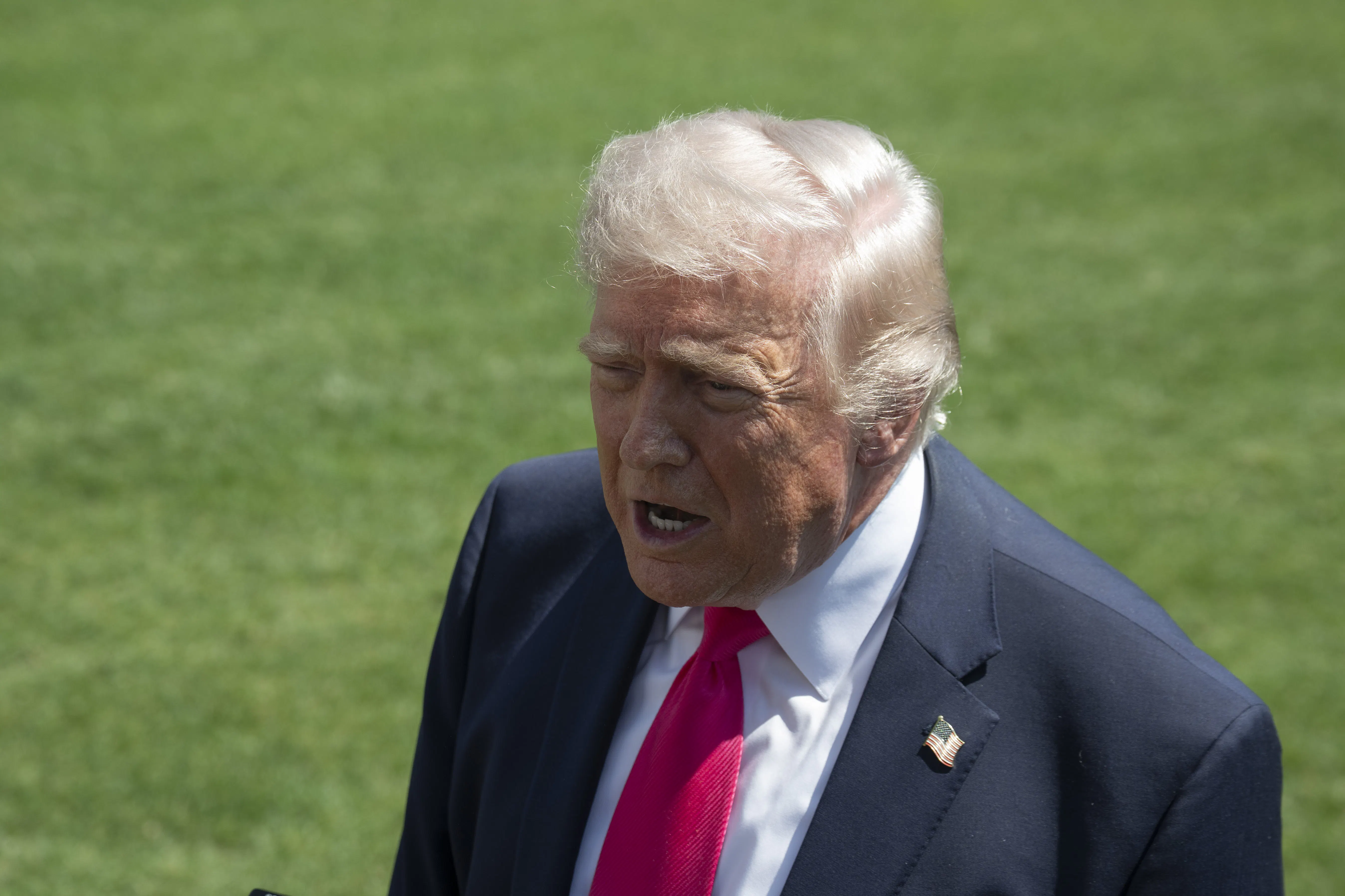 Donald Trump speaks to reporters outside the White House