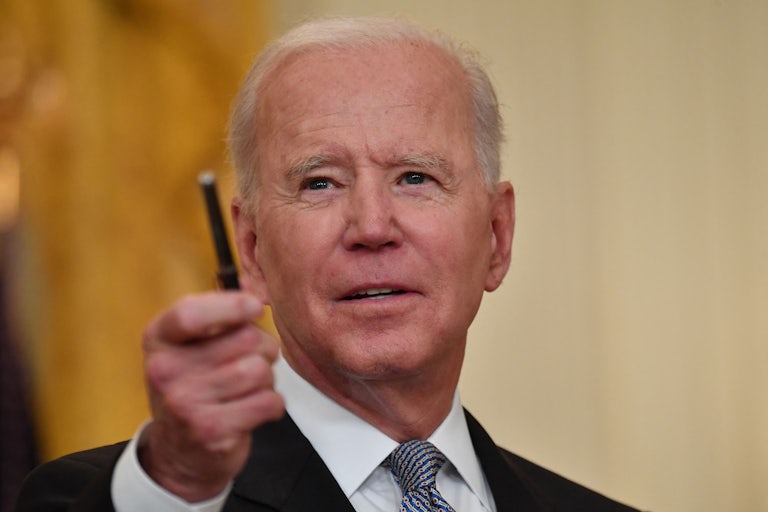 Biden flashes a pen at reporters as he takes questions at the White House.