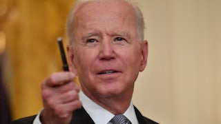 Biden flashes a pen at reporters as he takes questions at the White House.