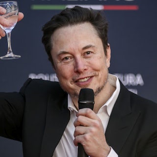 Elon Musk raises a glass as he speaks at a political convention organized by Fratelli d'Italia in Rome, Italy. 