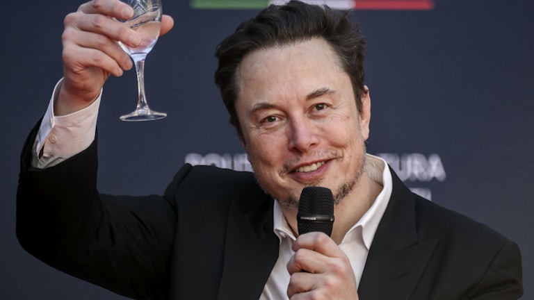 Elon Musk raises a glass as he speaks at a political convention organized by Fratelli d'Italia in Rome, Italy. 